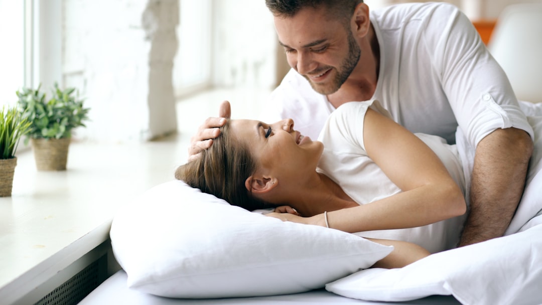 Couple in bed looking at each other lovingly.