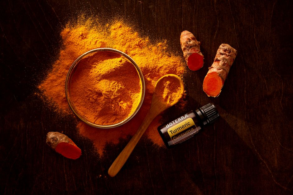 Turmeric roots and ayurvedic herbs on wooden table