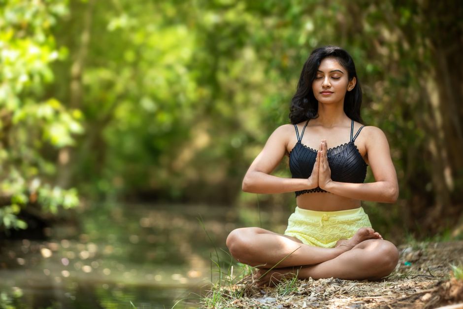 Woman in tree pose on serene outdoor background
