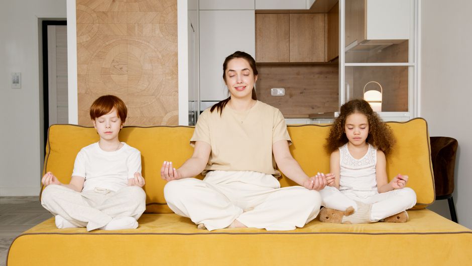 Mother meditating with calm child in nature