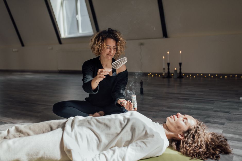 Woman meditating with glowing chakras symbolizing inner balance