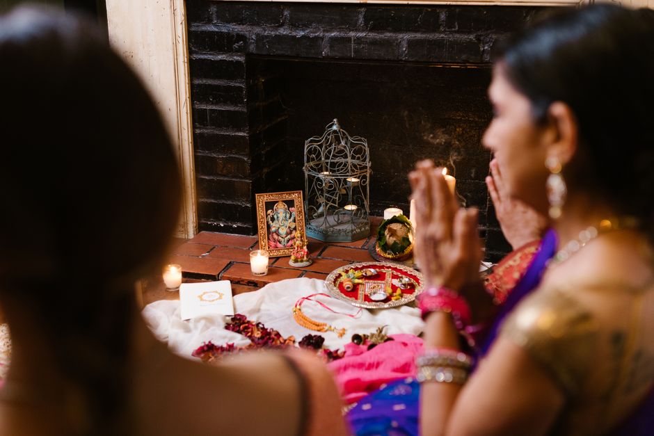 Person meditating with hands in prayer position outdoors