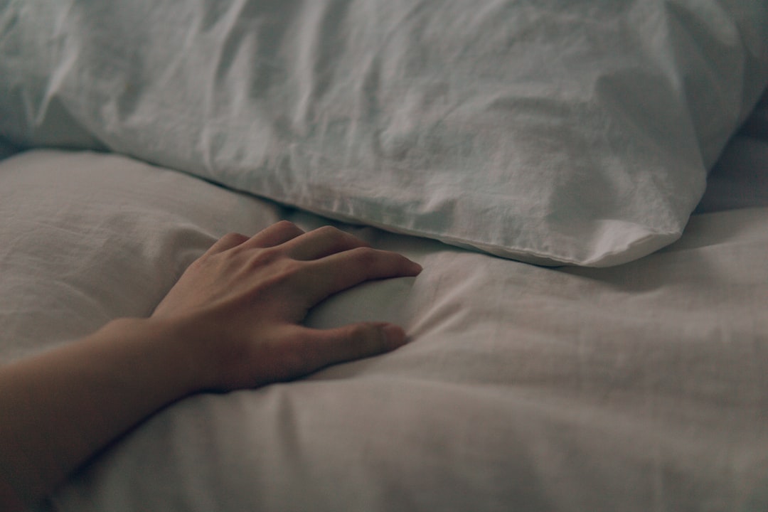 persons left hand on white textile