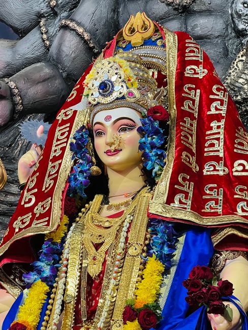 Durga idol with Hindu scriptures and prayer beads