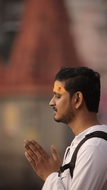 Person meditating with hands clasped in prayer