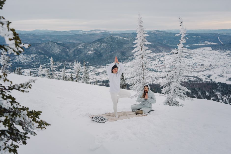 Woman practicing yoga outdoors in winter landscape